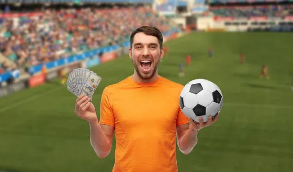 Happy football fan with soccer ball and money — Stock Photo, Image